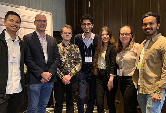 Medical physicist John Kildea (second from left) connects patient-centred data, mobile health technologies and AI research to improve the experiences and outcomes of patients, as well as investigating the biophysical mechanisms through which radiation causes and cures cancer. He is pictured here with students from his lab at a recent conference in Quebec City.