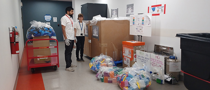 Ali Salim (Technical Services) and Marie Lamarche (Metabolic Disorders and Complications Program, MeDiC) are ready for the recycling pickup at the MeDiC program.