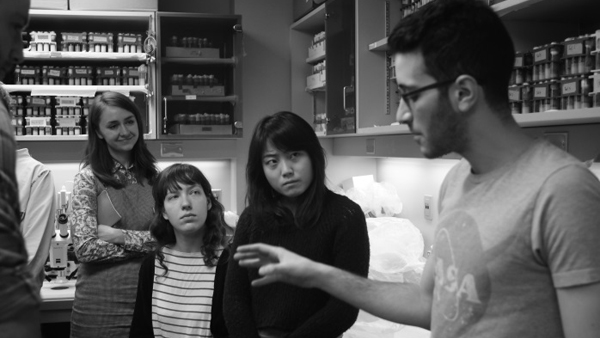 Dr. Ibrahim El Cheikh Kays explains his work to fine arts students Alexandra Bachmayer (left) and Nien Tzu Weng (right). Photo: Kevin Jung-Hoo Park