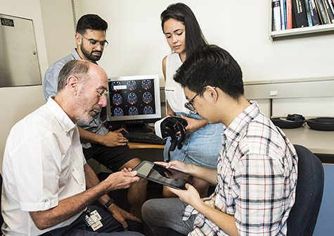 Robert Hess, PhD, and research trainees test an android tablet developed by Ubisoft for therapeutic video games