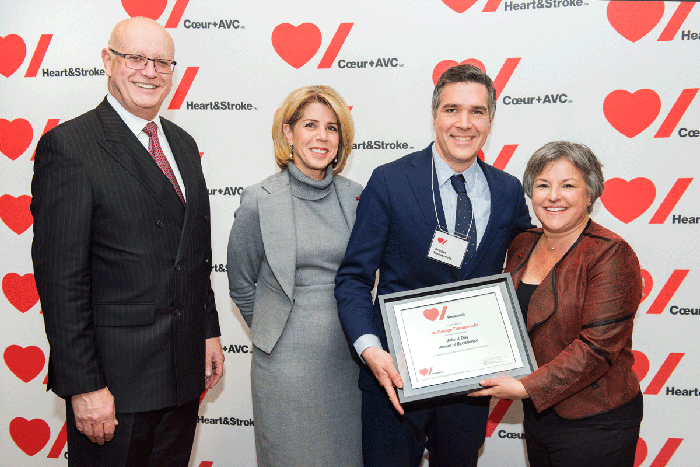 RI-MUHC researcher George Thanassoulis (blue suit) accepts the John J. Day M.D. Award of Excellence from Jean Raymond, Outgoing Chair, Provincial Board, Heart & Stroke; Dana Ades-Landy, CEO, Québec, Heart & Stroke; and Kostia Pantazis, Chair, Provincial Board, Heart & Stroke.