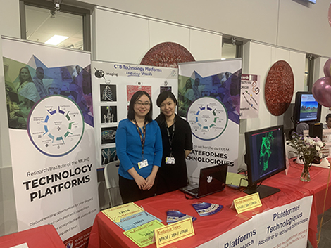 Shibo Feng, M.Sc. (left), and Min Fu, PhD (right), of the Molecular Imaging Platform, animate the Technology Platforms Kiosk (Behind the Scenes event at the Research Institute of the MUHC, November 13, 2019)